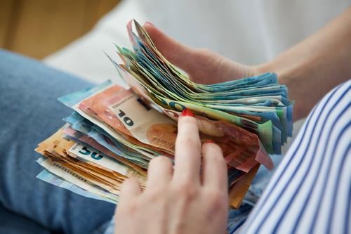 Traveller's cash box | Young woman holds a stack of banknotes in her hands and counts through. Money Bank note Euro Loose change figures Save Income Luxury