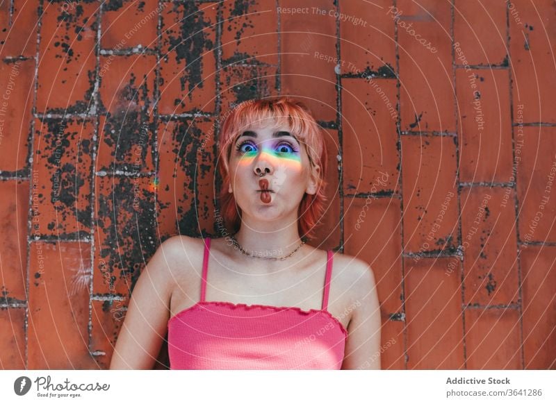 Happy woman making fish mouth millennial pink hair make face carefree rainbow behavior expressive female grimace different creative modern happy trendy street