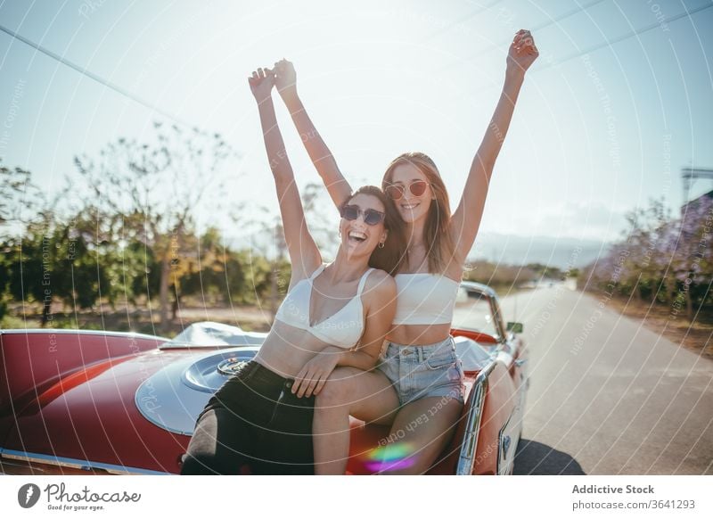 Delighted girlfriends having fun in summer on road vacation enjoy women cabriolet car carefree cheerful together holiday smile happy travel freedom nature