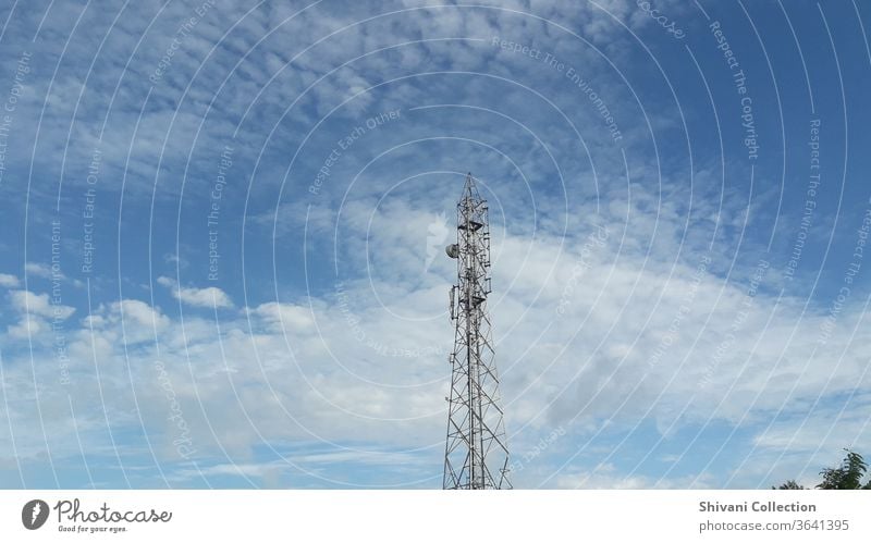 Telecommunication tower on blue sky and white fluffy clouds abstract background. Copy space nature and environment concepts. Antenna Broadcasting tower