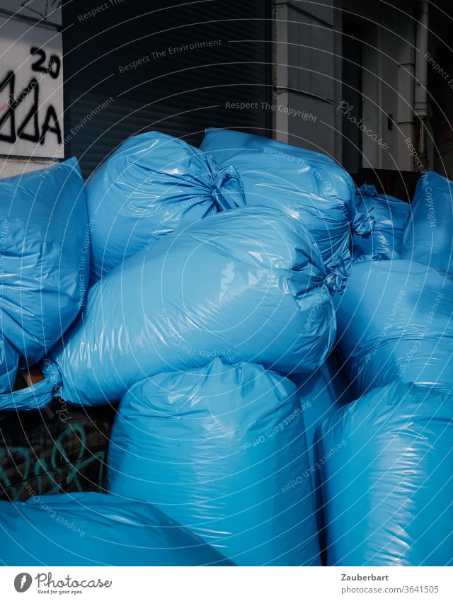 Blue plastic garbage bags are piling up on the street Garbage bag pile plastic foil Trash waste Stack Throw away Environment Waste management Recycling