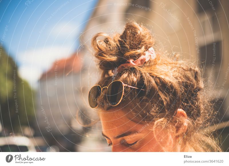 A young woman with sunglasses and bun in her hair in the sun Chignon Sunglasses Summer sunny Summery sunshine Vacation mood hairstyle pinned up Knot Topknot