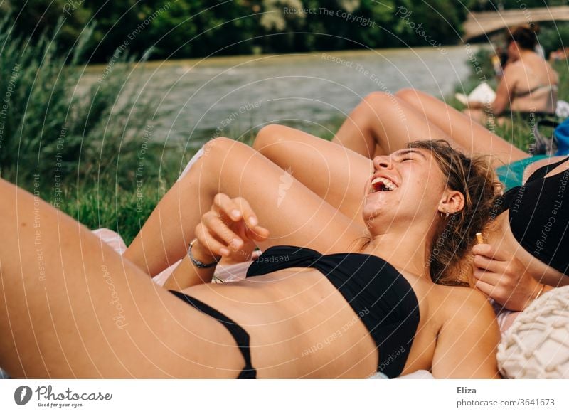 Young woman in bikini enjoys the sun and laughs with her friends picture