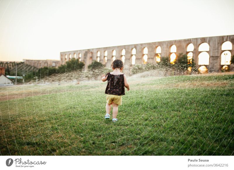 Child playing with water sprinklers Water Summer Summer vacation Garden Park outdoors Refreshment refreshing Day Joy Exterior shot Lawn Rain Drops of water