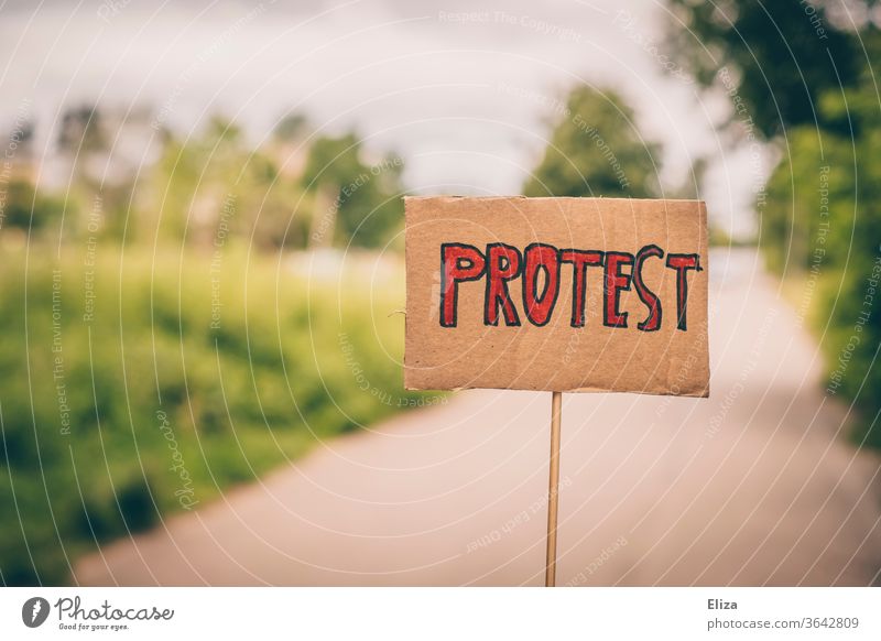 A sign with the word protest on it authored Word resistance on the other hand Demonstration Signs and labeling Solidarity Democracy Strike furious Protest