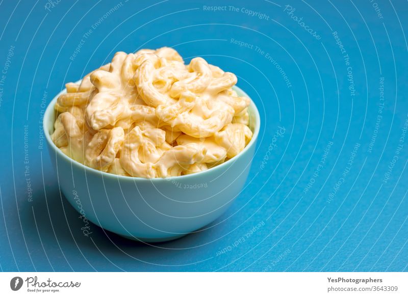 Mac and cheese in a blue bowl. Macaroni with cheese american american food bechamel sauce carbs cheddar cheesy close-up comfort food copy space cream creamy