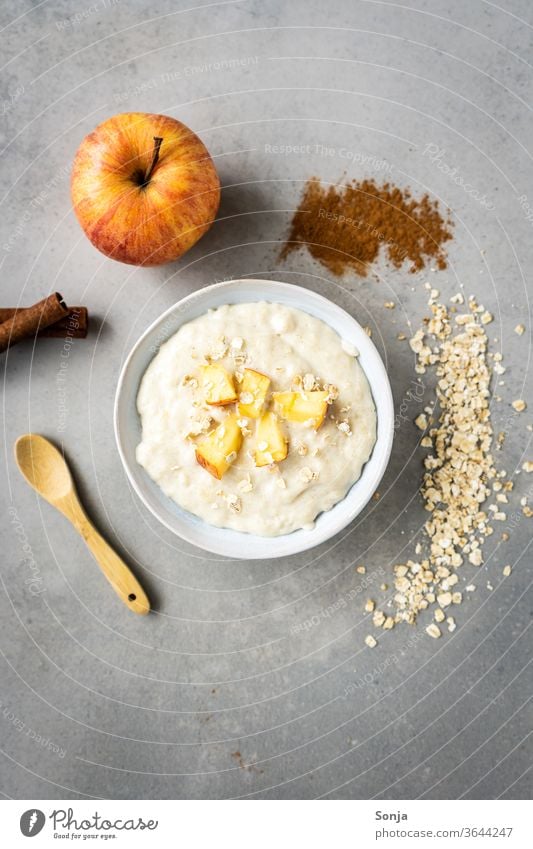 Warm porridge with apple in a white bowl. Ingredients, rustic background apples Breakfast Oat flakes Bowl Meal Organic Oats natural Morning Spoon Snack warm