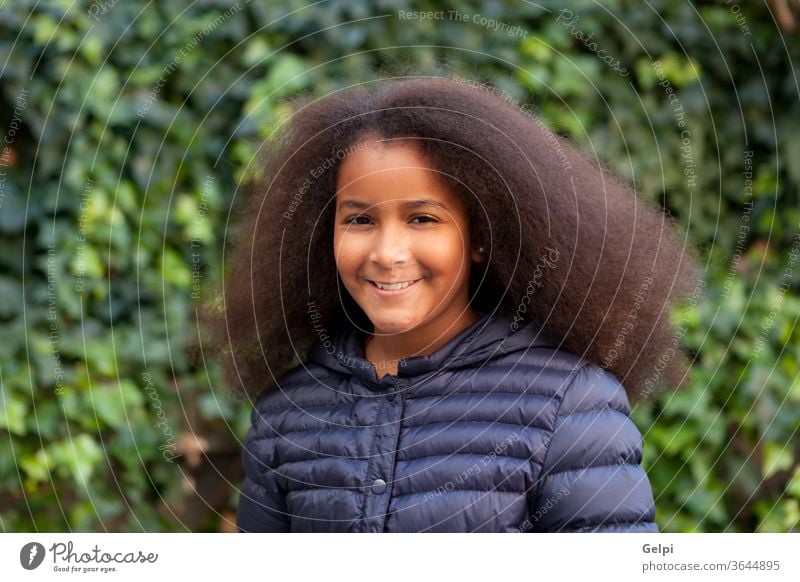 Pretty girl with long afro hair with a blue coat person brunette people african portrait happy american child black one childhood looking 9 cheerful children