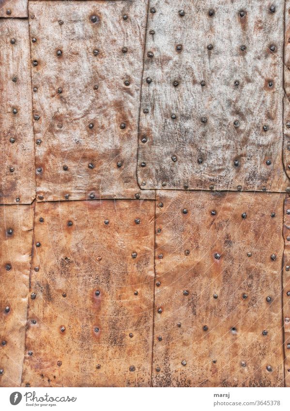 Riveted sheet iron panels that protect a door from the weather patchwork Tin Iron Stud Rust rusty metal Protection lap overlap Wallpapers Patina Oxydation Metal