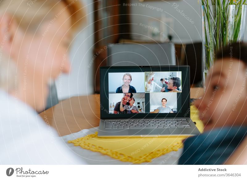 Cheerful mother and son having video conference call on laptop video call using excited relative quarantine social distancing chat covid 19 happy coronavirus