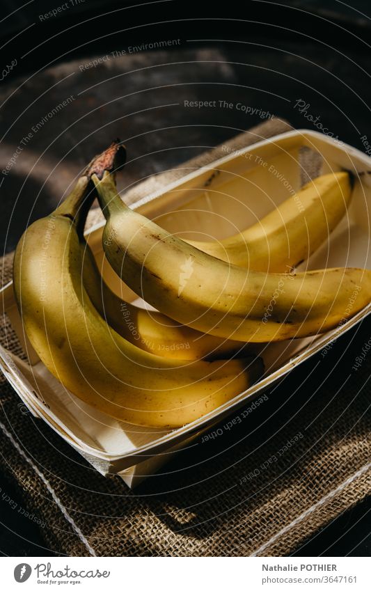 Bananas in tray Yellow burlap Fruit fruits light sunny sunbeam summer Food Fresh Nutrition Vitamin Colour photo Healthy Healthy Eating Food photograph