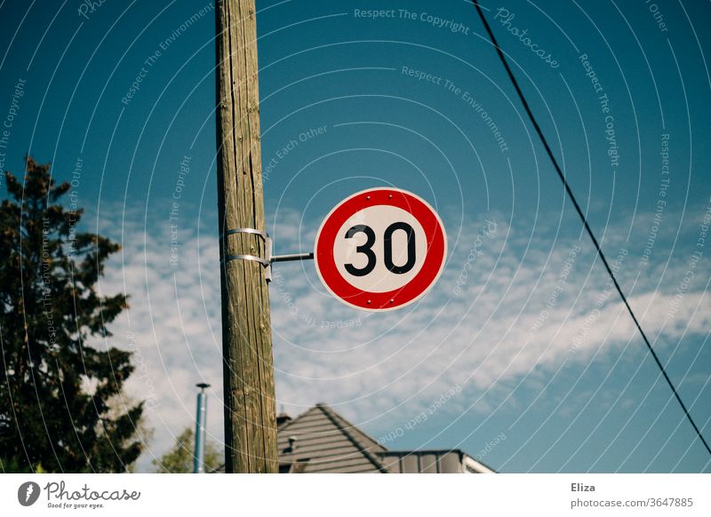 Traffic sign 30 zone. Speed limit. 30 mph zone Road sign Street Transport Signs and labeling Road traffic Blue sky Residential area attentiveness Protection