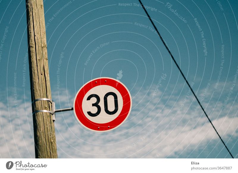 Traffic sign 30 zone. Speed limit. 30 mph zone Road sign Street Transport Signs and labeling Road traffic Blue sky Residential area attentiveness Protection Sky