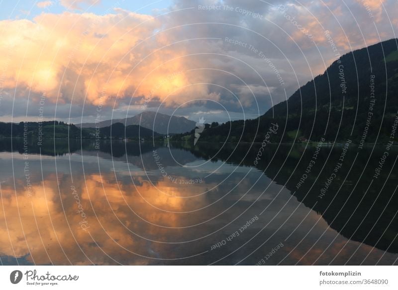 Cloudy evening sky and chain of hills reflected in a lake reflection Lake Hill Landscape Clouds Sky Mountain Water reflection Allgäu alpine lake Reflection