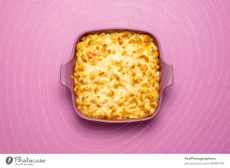 Mac and cheese oven-baked, top view. Macaroni with bechamel sauce in a pink tray above view american carbs cheddar cheesy comfort food cooked copy space cream