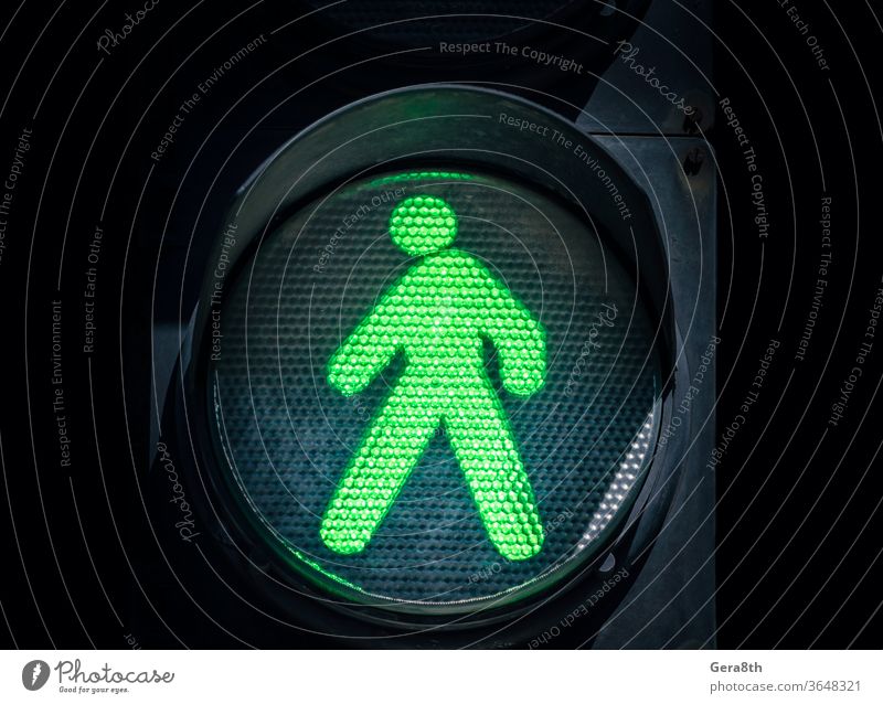 traffic light with a green man on a black background LED abstract admit allow authorize blue city close up color consent crosswalk dark dot electric enable