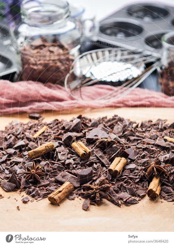 Shredded chocolate with cinnamon for baking shredded spice dark christmas food wooden board other ingredients tools sweet cooking gourmet delicious prepare