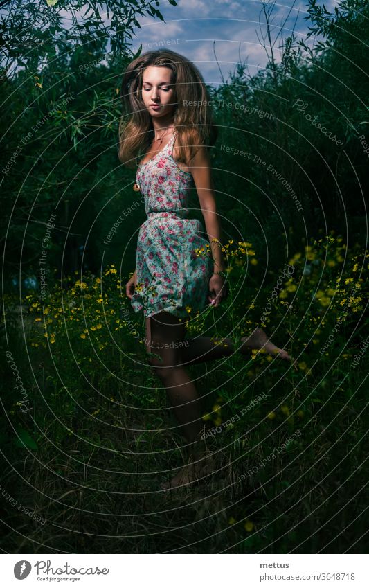 Mysterious girl running in the summer field of tall grass in the night blonde free freedom wind young woman dress candid shot beautiful fly fashion spring