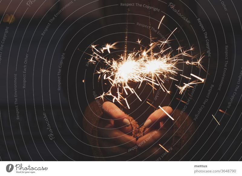 Female hands holding two burning sparklers award bokeh celebrating congratulations eve exploding explosion flame flare glow laughing magic occasion star bengal