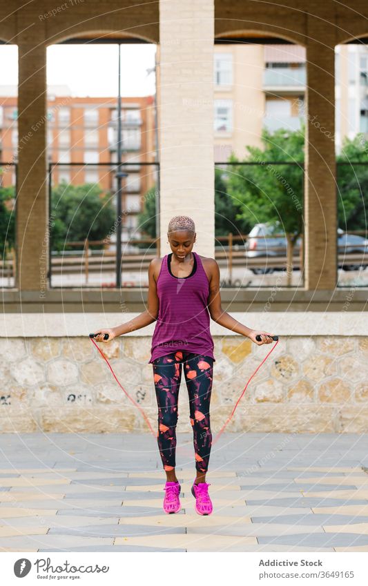 Black sportswoman jumping rope on embankment in city during workout - a  Royalty Free Stock Photo from Photocase