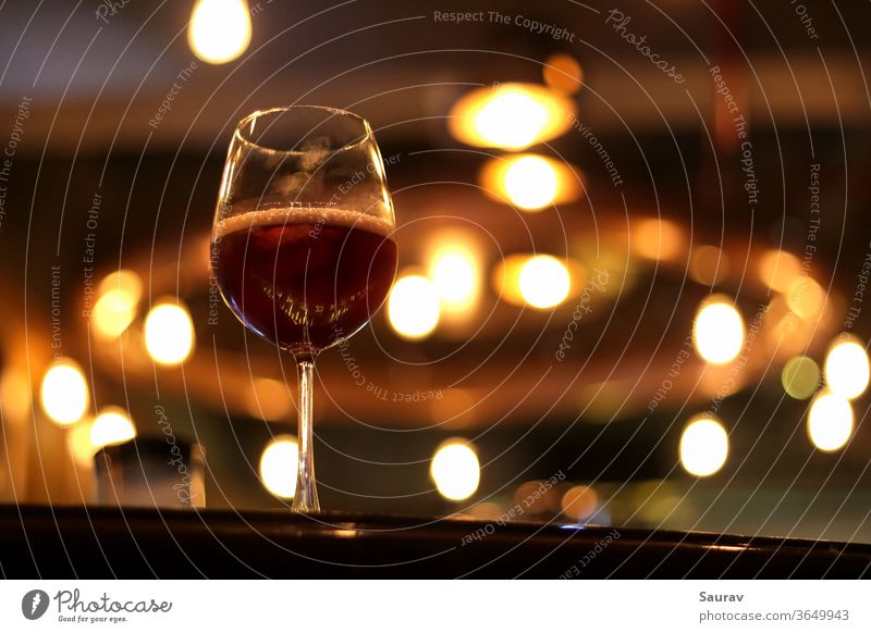 One Goblet filled with Red Wine with thumbprints on it. food and drink alcohol cuisine red wine lifestyle goblet glass wineglass sangria bar indoor lights color