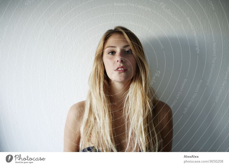 Portrait of a beautiful, young, blonde woman in front of a white wall portrait Woman Young woman Blonde already Slim Long-haired Esthetic Model Identity