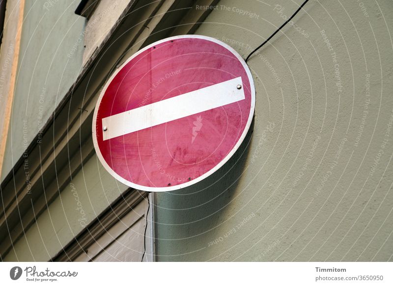 Traffic sign "no entry" on house facade Road sign No entry Signs and labeling Road traffic Bans Colour photo Cornice Cable White Red Subdued colour