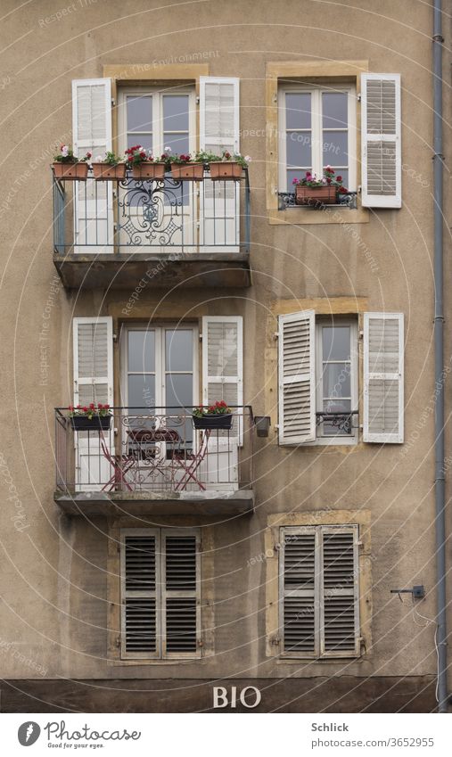 Façade of a residential building above a health food store in Metz Lorraine Facade Apartment Building organic Old metz Balconies folding shutter wood downspout