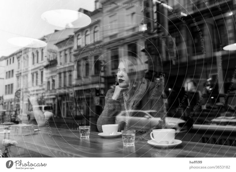 the young woman waits in the coffee shop and looks dreamily and thoughtfully out of the window Face of a woman Young woman Woman 1 portrait Youth (Young adults)