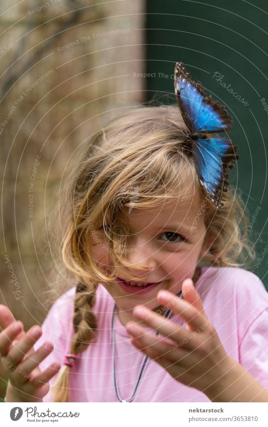 Portrait of Happy Blond Girl With Blue Butterfly in Hair child portrait happy girl smiling outdoor nature beauty in nature blue day summer caucasian ethnicity