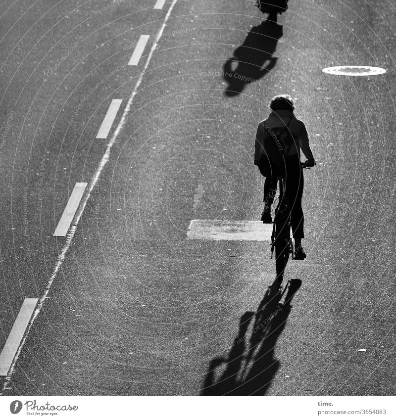 closing time Bicycle Cyclist Street Asphalt Tar mark B/W Shadow Silhouette Line cycle path Back-light Rear view Movement In transit