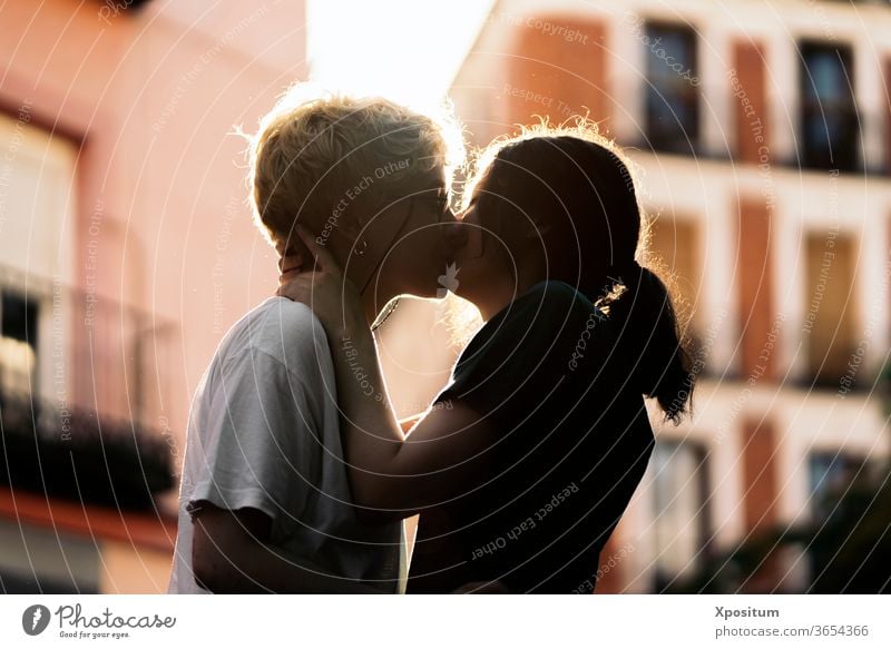 Young lesbian couple kissing date closeup close up unrecognizable young women together togetherness holiday sun diversity freedom joy romantic vacation