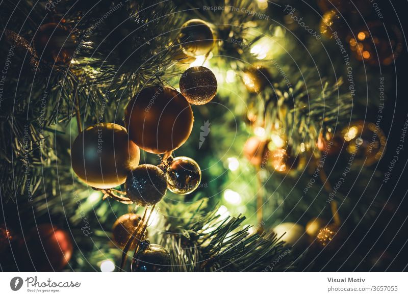 Traditional Christmas tree garland with baubles hanging on illuminated branches at night traditional Xmas light holiday celebrate winter festive green season