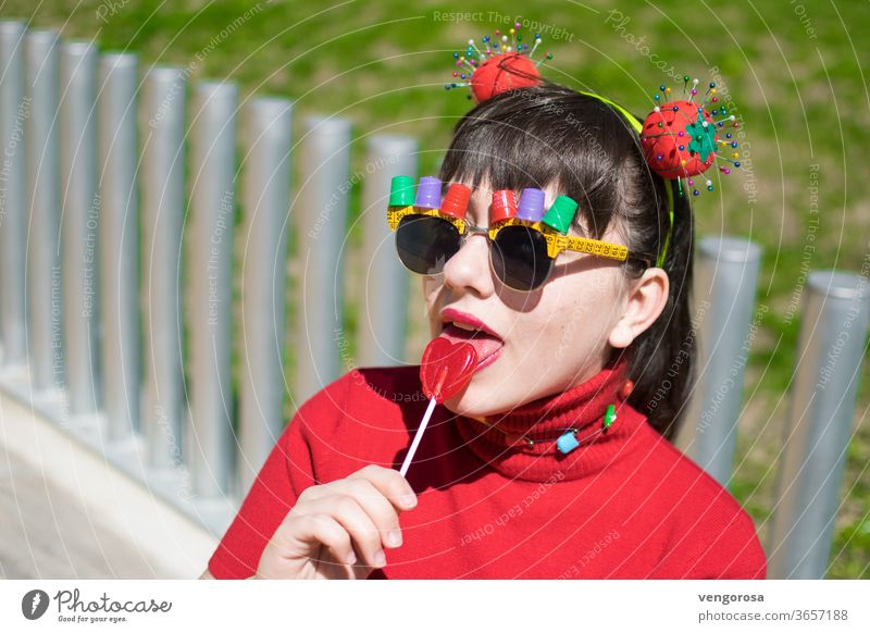 Pin-up teen with sewing accessories and eating a lollipop young girl Multicoloured Red teen girl teenage teenager Fringe pretty beauty portrait fringe hairstyle