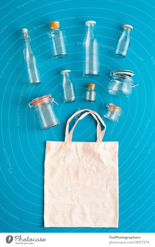 Plastic-free containers for groceries. Glass bottles and jars top view above view background bag blank blue bulk shopping buy clean concept conservation cotton