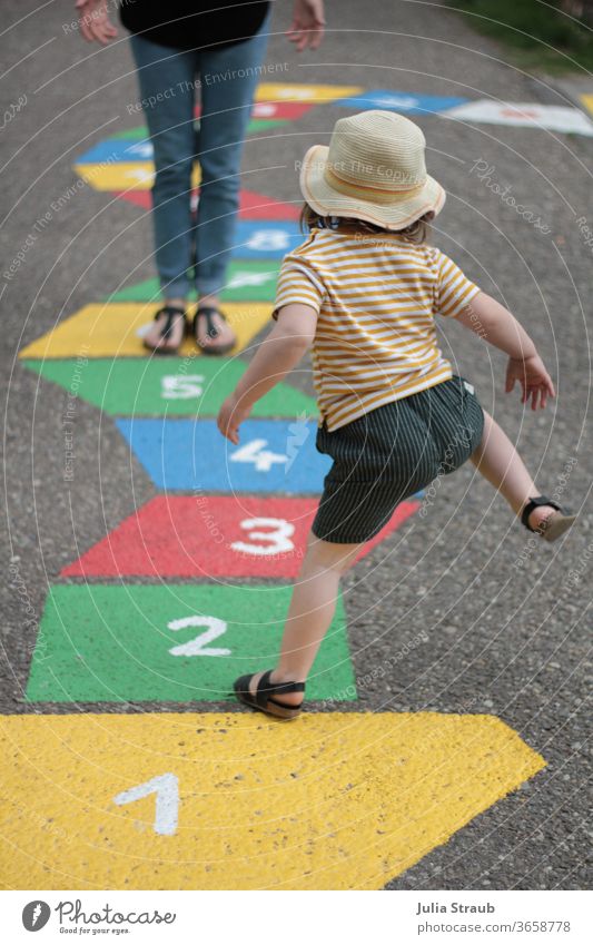 1 2 3 Toddler with hat and striped t-shirt in sandals jumping a street game heaven & hell girl Striped Summer Funny wittily Jump Hop Adults toe step Sandals