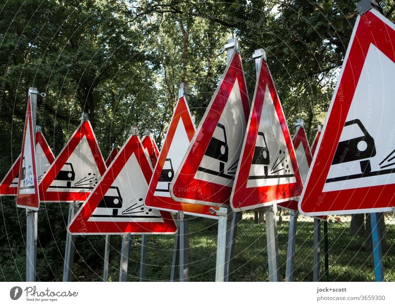 One cannot warn often enough of uncontrolled flying loose chippings Road sign Triangle StVO rolled gravel Signs and labeling Warning sign Red Many Collection