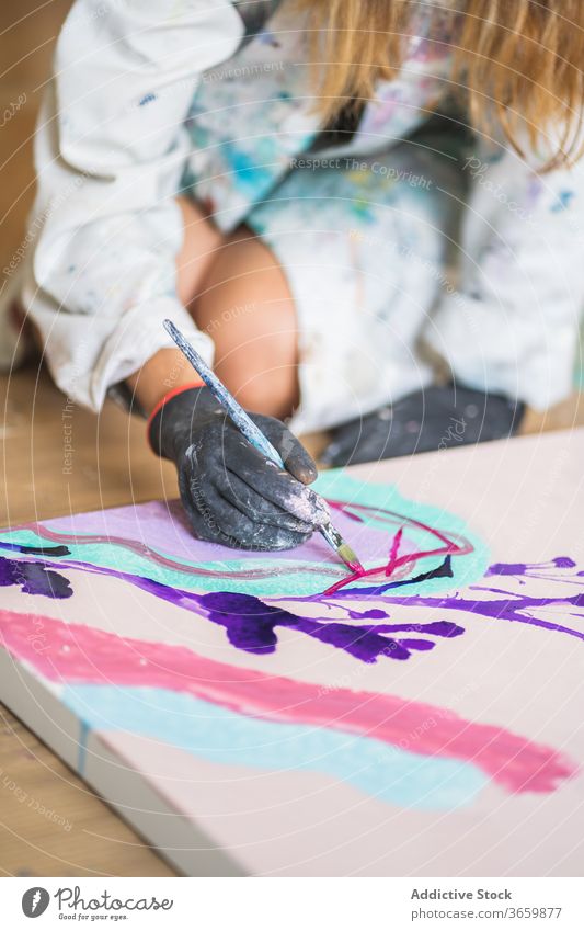 Crop unrecognizable artist with paintbrush mixing paints on palette talent craft process gouache workshop glove dirty plastic illustration studio robe woman