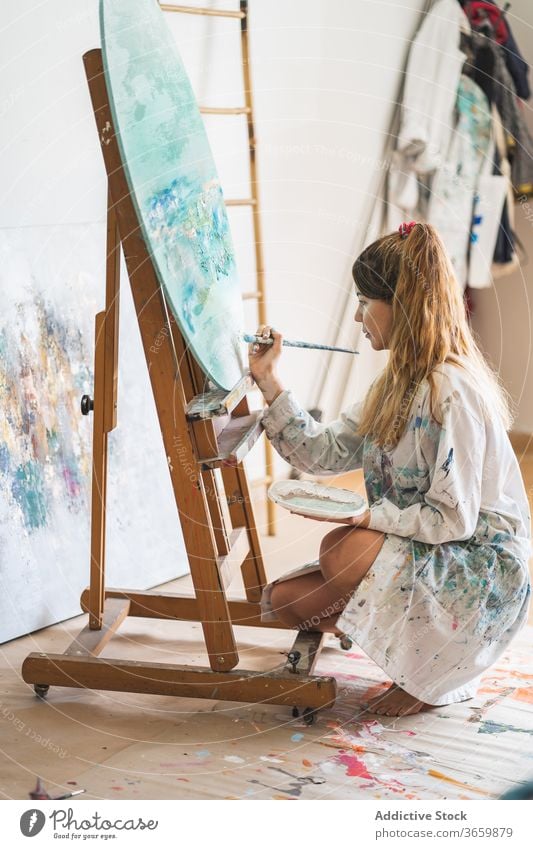 Female artist painting picture on easel canvas seascape woman creative talent young female paintbrush draw lifestyle hobby inspiration craft artwork painter