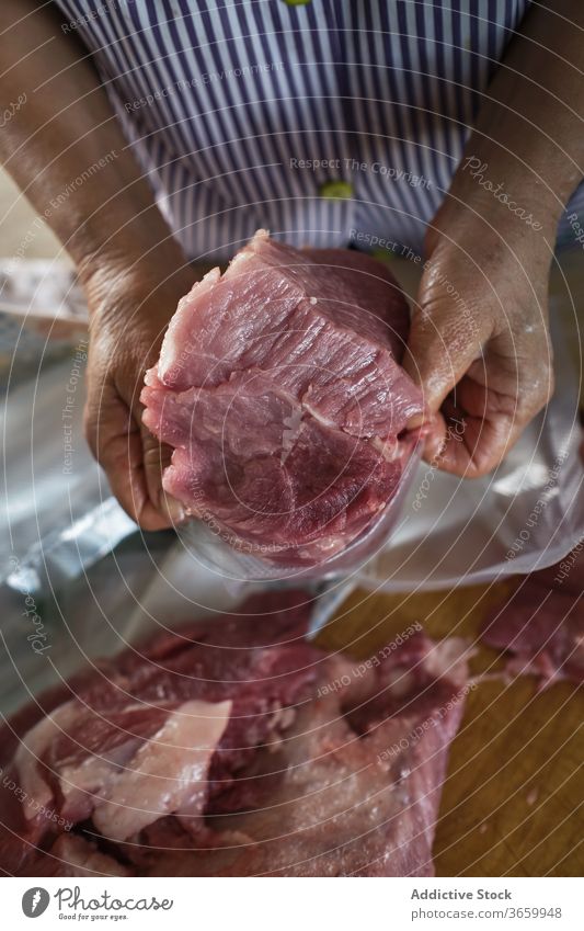 Man cutting meat on chopping board stock photo