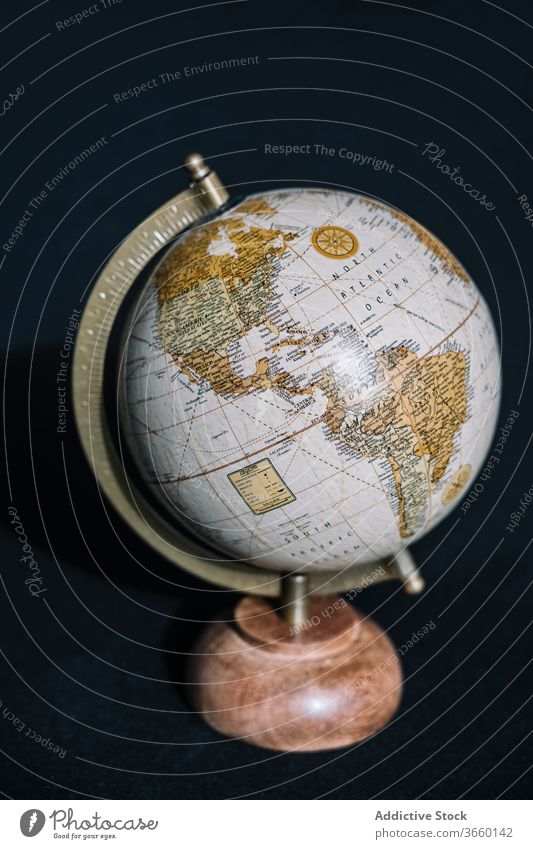 Desk globe of Earth on black background map cartography earth planet world display cozy geography america education travel information school contemporary