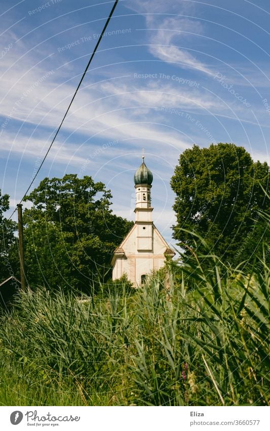 Church in the green, surrounded by trees and blue sky. Nature Green Sky Church spire Religion and faith Building Christianity Manmade structures Meadow Grass