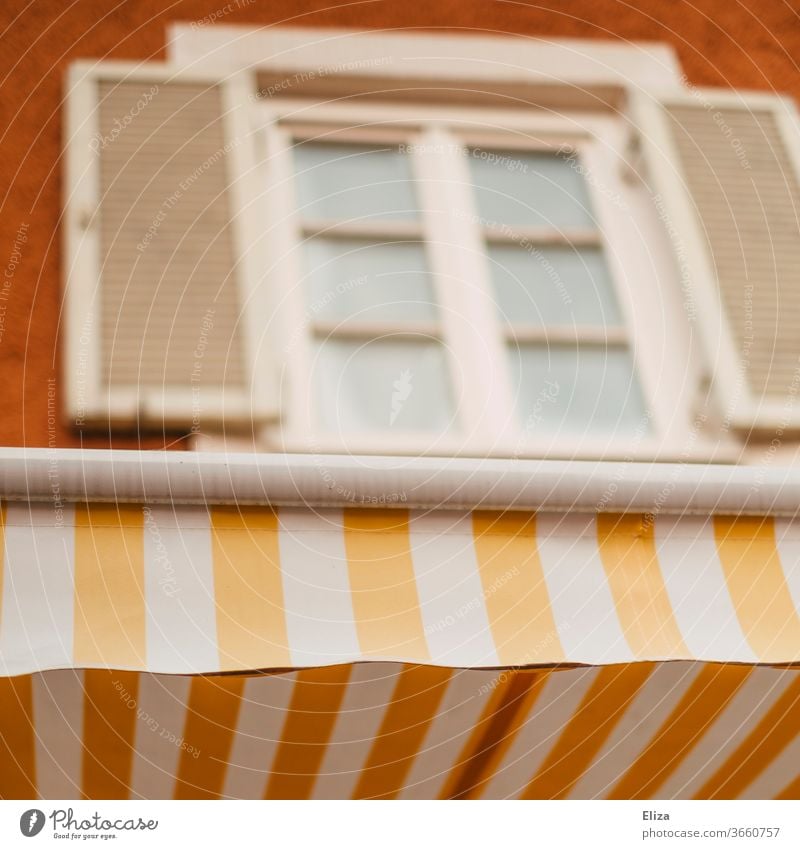 Yellow and white striped awning on a pretty facade Sun blind White Striped Facade kind Old building Window built House (Residential Structure) Old town