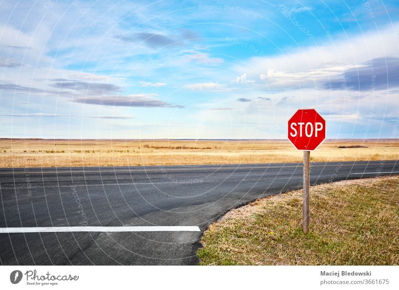 Stop road sign at an intersection in Badlands National Park, USA. stop travel trip highway nature landscape rural South Dakota freedom scenery adventure horizon