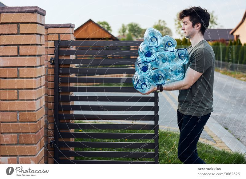 https://www.photocase.com/photos/3662626-young-man-throwing-out-empty-used-plastic-water-bottles-into-trash-bin-collecting-plastic-waste-to-recycling-concept-of-plastic-pollution-and-too-many-plastic-waste-environmental-issue-photocase-stock-photo-large.jpeg