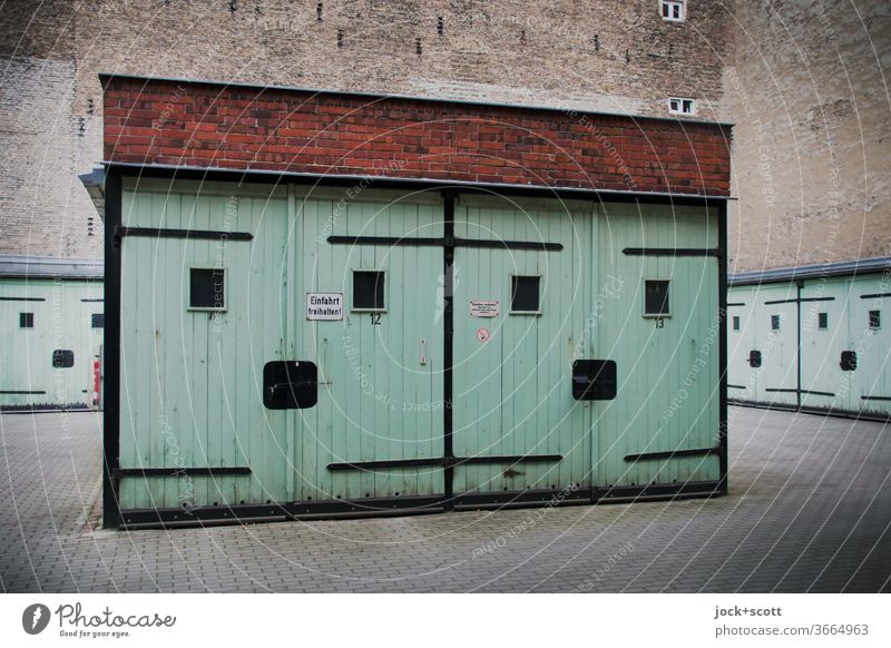 friendly multi-purpose garages from DDR times Garage Architecture Multi-purpose garage GDR Turquoise Prenzlauer Berg Fire wall Garage door Retro Ravages of time