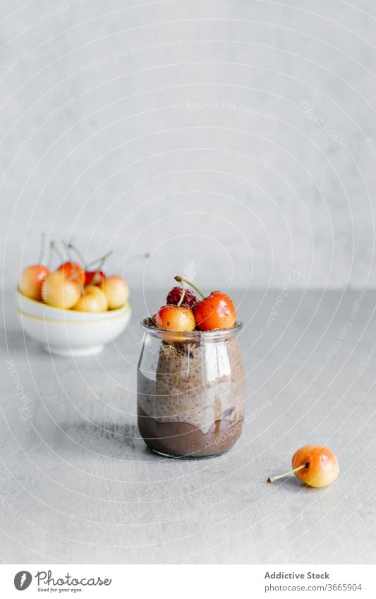 Delicious chocolate chia pudding with white cherries on top dessert organic breakfast berry seed white berry jar glass sweet delicious food natural nutrition