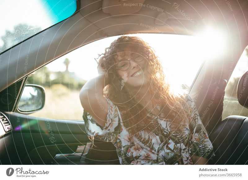 Happy woman inside car sunshine cheerful toothy smile happy joy positive weekend feminine eyeglasses charming enjoy glad casual wear female summer eyewear