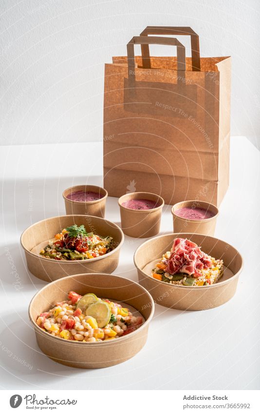 Various healthy food in takeaway bowls on table various delicious eco friendly package container shrimp ceviche beetroot cream rice paper carton prawn ceviche