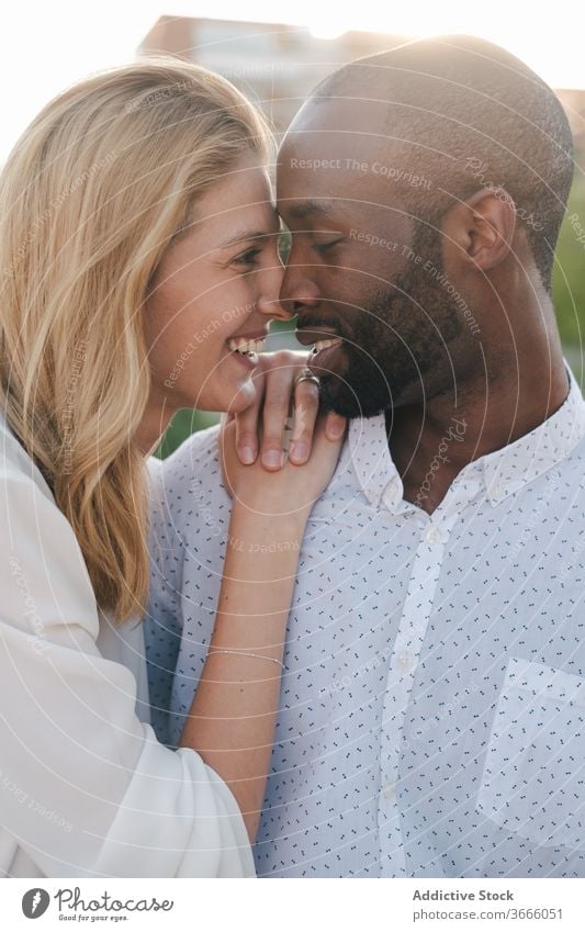 Tender multiracial couple hugging each other lovingly bonding rest in love romantic content tender sensual eyes closed cuddle happy cheerful fondness affection